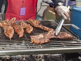 Man grilling rib tips on a grill